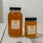 Two jars of Wildflower Raw Honey from The Fat Lady, showcasing unfiltered honey in glass jars, ideal for skincare and cooking.