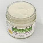A jar of Catnip & Neem Tallow Bug Repellent with a white cream product visible inside a clear glass jar, set against a plain white background.