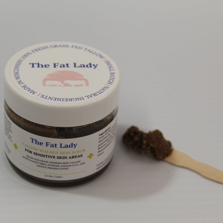The Fat Lady Tallow Glow Exfoliating Scrub for sensitive skin, 2.5 oz, featuring a jar of natural skincare with a smooth texture.