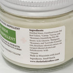 Close-up of a jar of bug repellent cream with a white lid and a white label showing the ingredients list for Neem and Peppermint Bug Repellent.