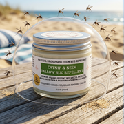 A jar of Catnip & Neem Tallow Bug Repellent sits on a wooden beach chair outdoors, with mosquitoes flying around it and a blurred beach background.